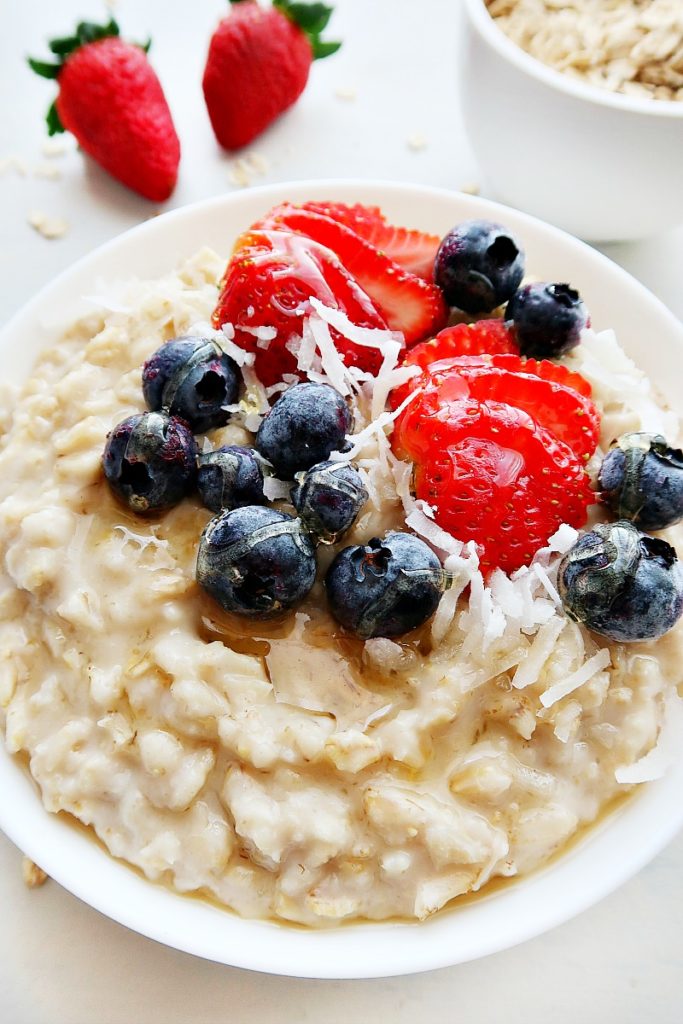 Cooked oatmeal with blueberries and strawberries.