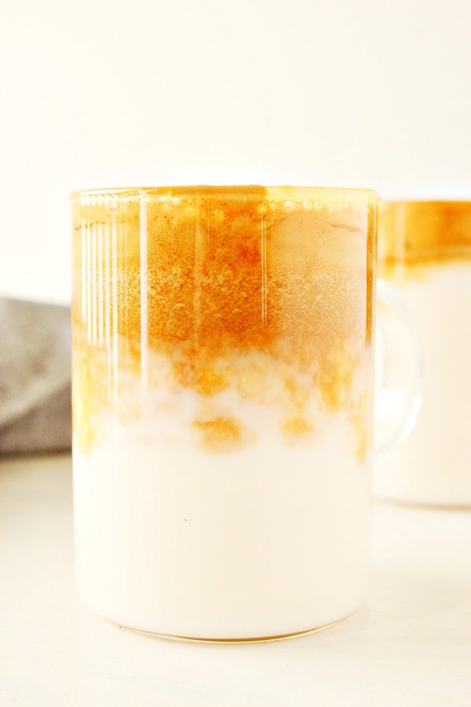 Milk and coffee foam in a mug.