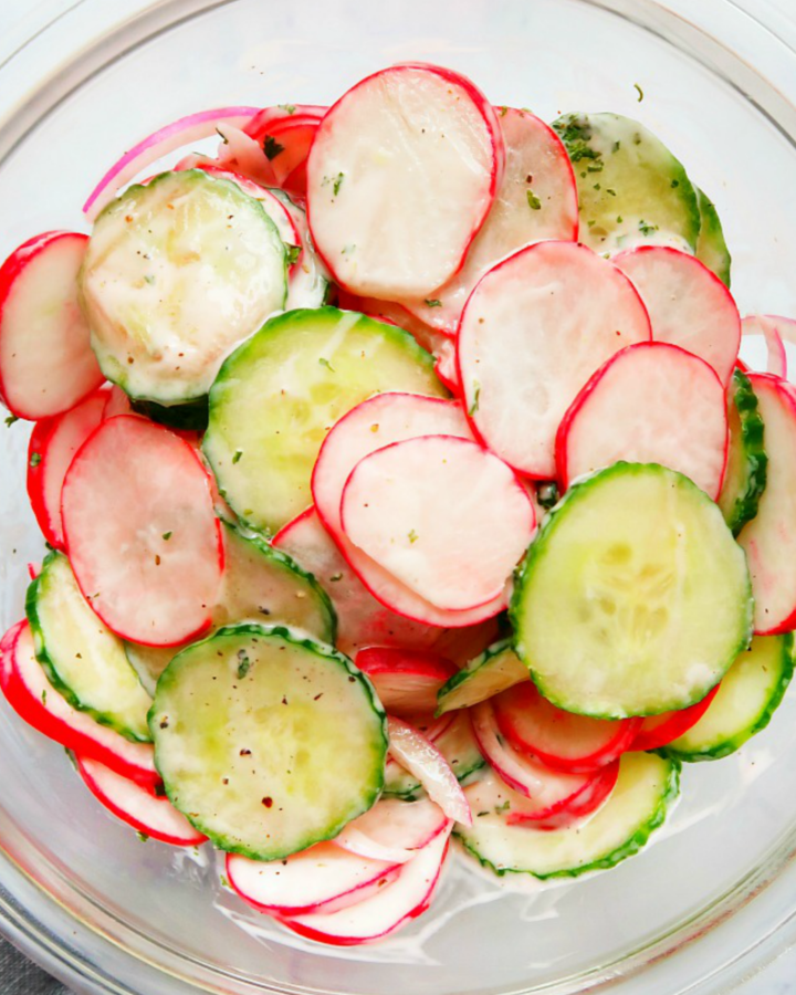 Sliced radishes and cucumbers in a bowl.