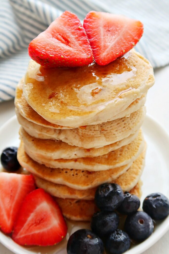 Pancakes with strawberries on top.