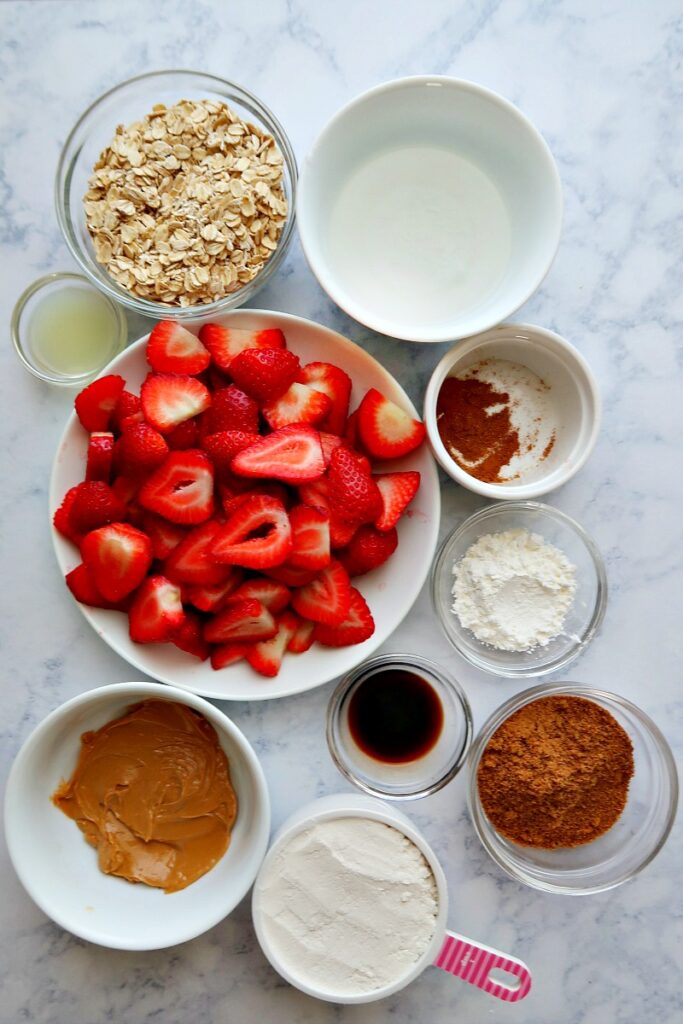 Ingredients for strawberry crisp on a board.