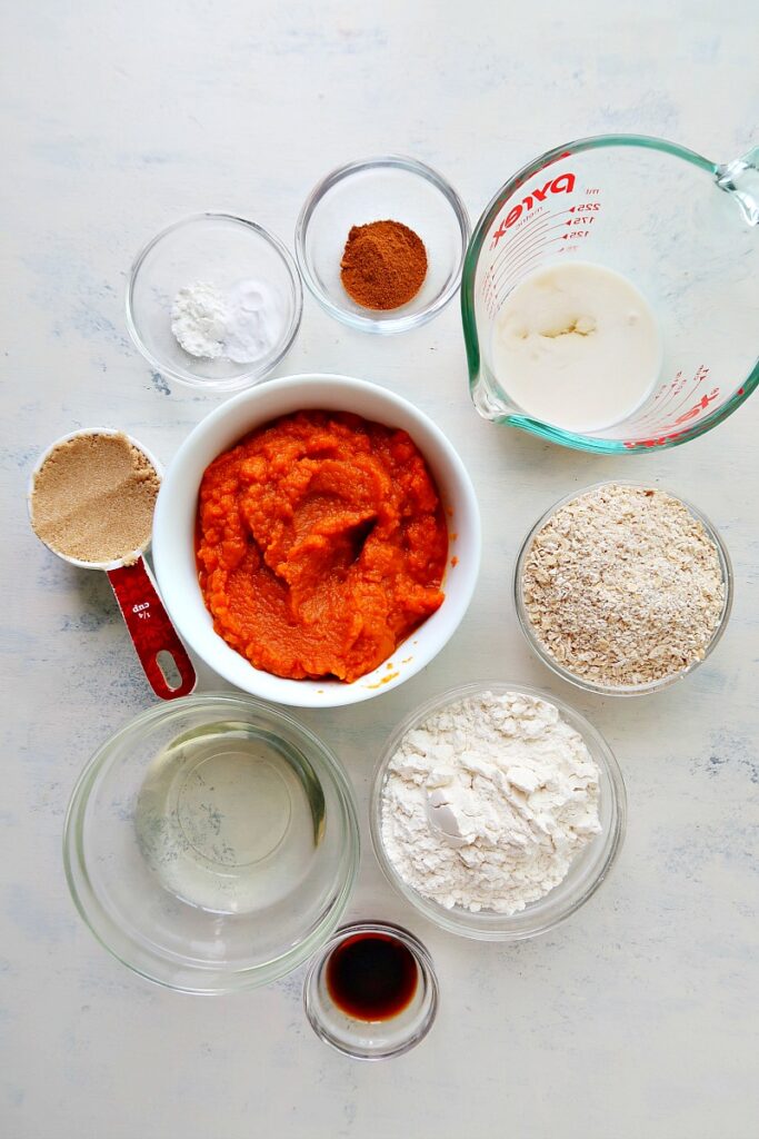 Ingredients for pumpkin muffins on a board.