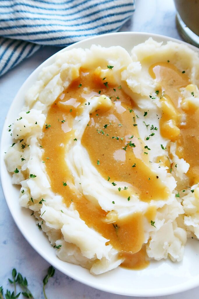Vegan mashed potatoes with gravy in a bowl.