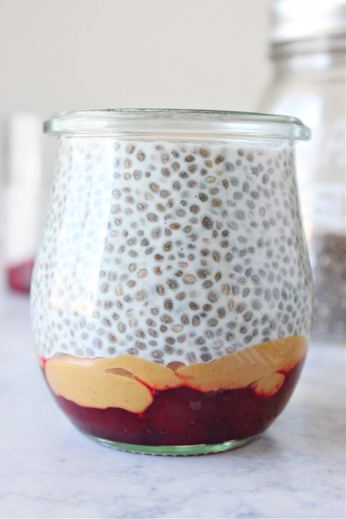 Chia pudding in a jar with peanut butter and jam.