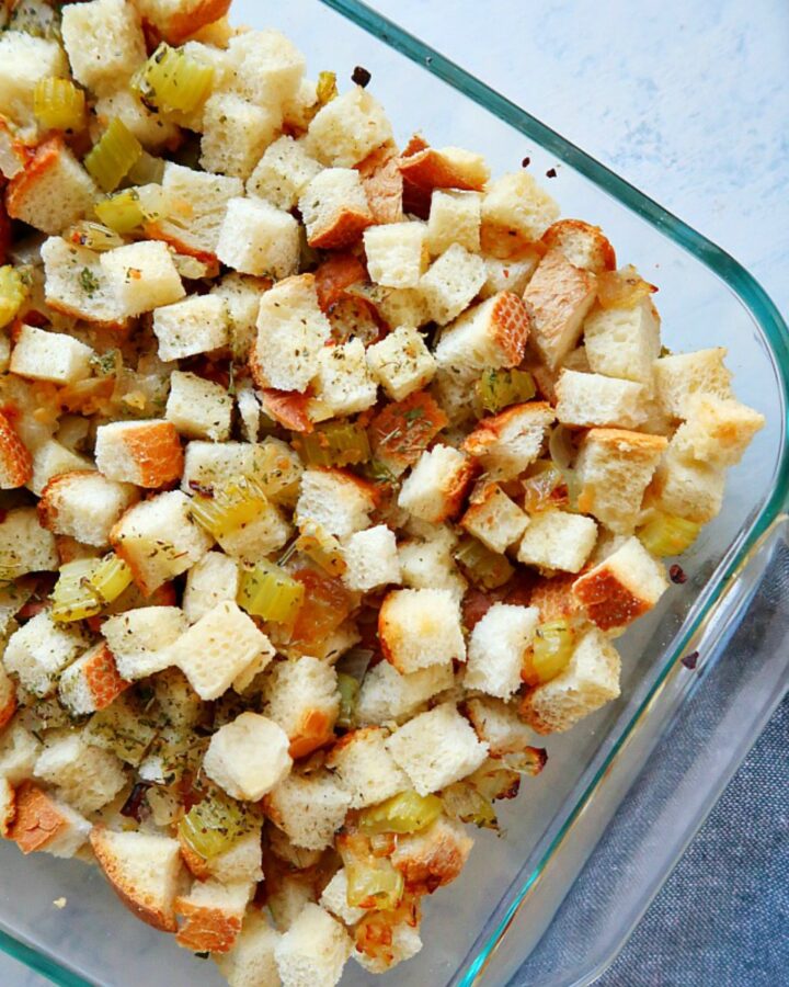 Stuffing in a baking dish on a board.